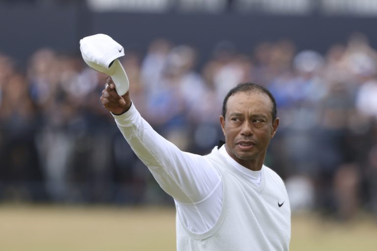 Tiger Woods salutes fans.
