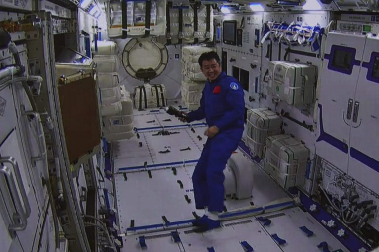 In this photo released by Xinhua News Agency, an image taken off the screen at the Beijing Aerospace Control Center shows Chinese astronaut Chen Dong inside the Wentian lab module on Monday.