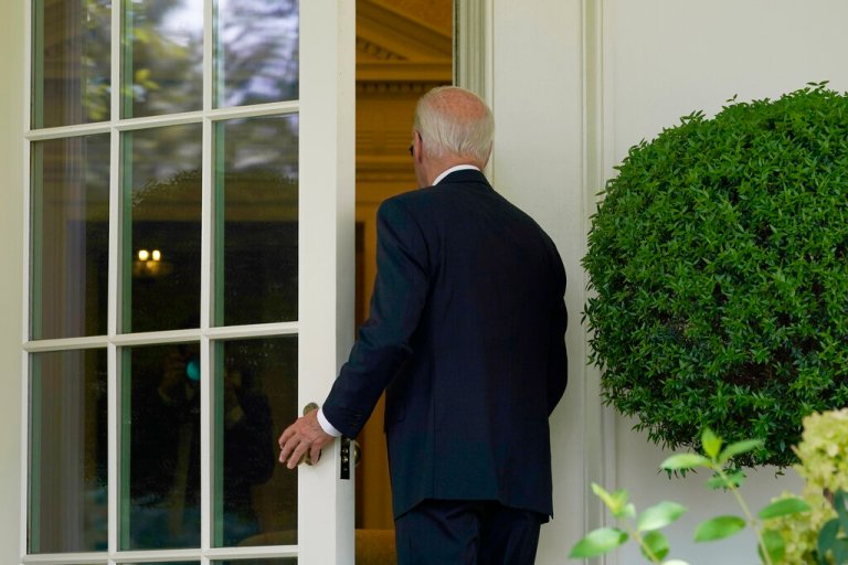 President Joe Biden walks into the Oval Office of the White House in Washington, Wednesday, July 27, 2022, as he returns to work in the Oval Office after recovering from COVID-19. He has now tested positive again.