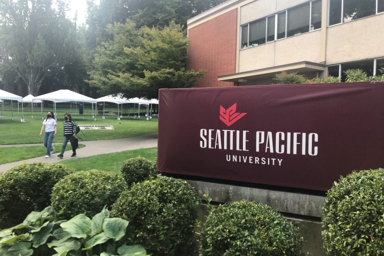 Students walk on the campus of Seattle Pacific University in Seattle on Sunday, Sept. 11, 2022. 