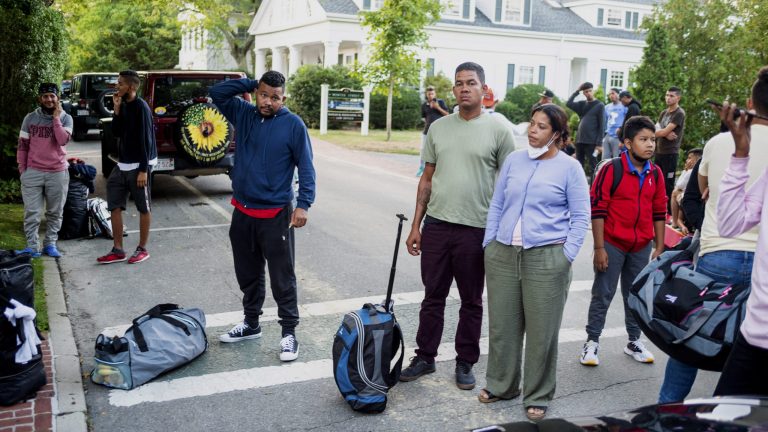 Immigrants gather with their belongings outside St. Andrews Episcopal Church, on Sept. 14 in Edgartown, Mass., on Martha's Vineyard. 
