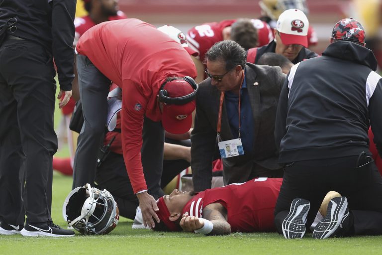 San Francisco 49ers head coach Kyle Shanahan talks to San Francisco 49ers quarterback Trey Lance (5) after Lance was injured in the first quarter of an NFL football game against the Seattle Seahawks, Sunday, Sept. 18, 2022 in Santa Clara, Calif.
