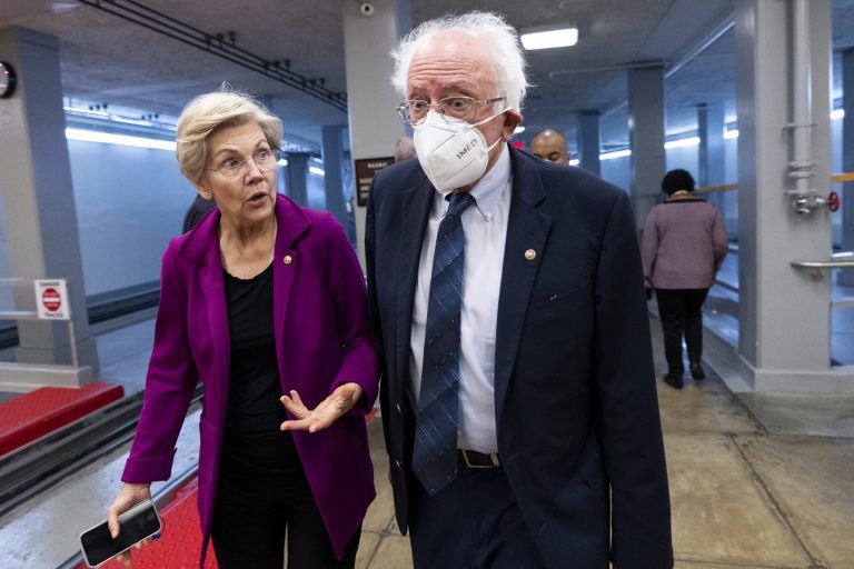 UNITED STATES - SEPTEMBER 22: Sen. Elizabeth Warren, D-Mass., and Sen. Bernie Sanders, I-Vt., walk through the Senate subway on their way to a vote in the Capitol on Thursday, September 22, 2022. 