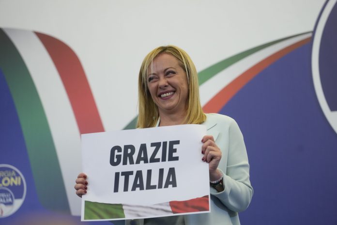 Far-right party Brothers of Italy's leader Giorgia Meloni shows a placard reading in Italian "Thank you Italy" at her party's electoral headquarters in Rome, early Monday, Sept. 26, 2022. Italians voted in a national election that might yield the nation's first government led by the far right since the end of World War II.