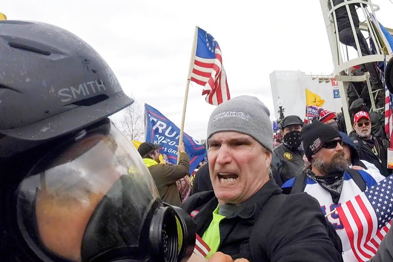 FILE - In this image from video, Alan William Byerly, center, attacks an Associated Press photographer during a riot at the U.S. Capitol in Washington, Jan. 6, 2021. On Sunday, Oct. 9, 2022, federal prosecutors recommended a prison sentence of nearly four years for Byerly, of Pennsylvania, who pleaded guilty to assaulting the AP photographer and using a stun gun against police officers during a mob's attack on the U.S. Capitol. 