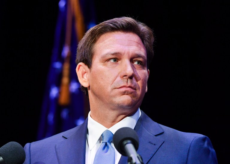 Florida's Republican Gov. Ron DeSantis takes to the stage to debate his Democratic opponent Charlie Crist in Fort Pierce, Fla., on Oct. 24, 2022.