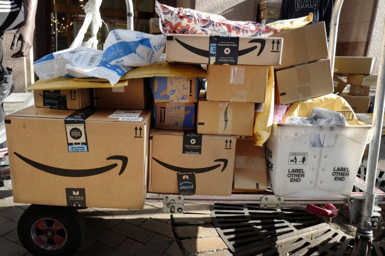 In this Oct. 10, 2018, file photo, Amazon Prime boxes are loaded on a cart for delivery in New York. The nationâs major shipping companies are in the best shape to get holiday shoppersâ packages delivered on time since the start of the pandemic, suggesting a return to normalcy. 