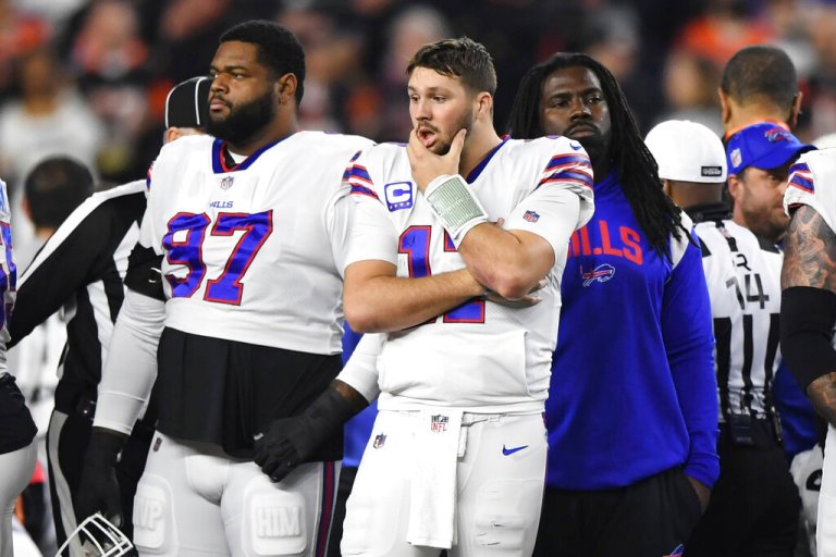 Buffalo Bills quarterback Josh Allen (17) pauses as Damar Hamlin is examined by medical staff during the first half of an NFL football game against the Cincinnati Bengals, Monday, Jan. 2, 2023, in Cincinnati. 