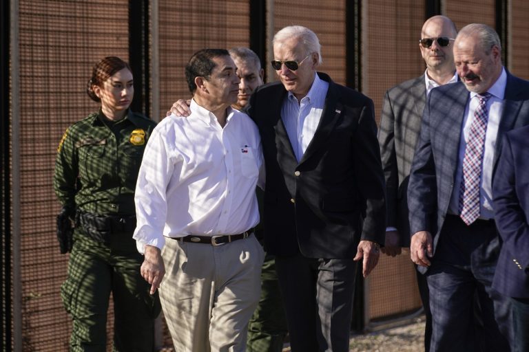 President Joe Biden talks with Rep. Henry Cuellar, second from left, as they walk along a stretch of the U.S.-Mexico border in El Paso, Texas, Sunday, Jan. 8, 2023. Oscar Leeser, mayor of the City of El Paso, is at right.