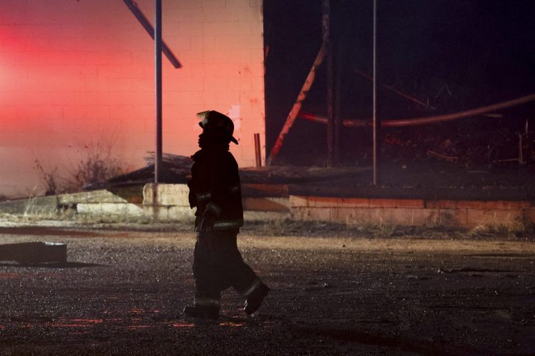 A Selma firefighter walks back the truck after putting out a fire that started from a tornado that passed through downtown Selma, Alabama, Thursday, Jan. 12, 2023.