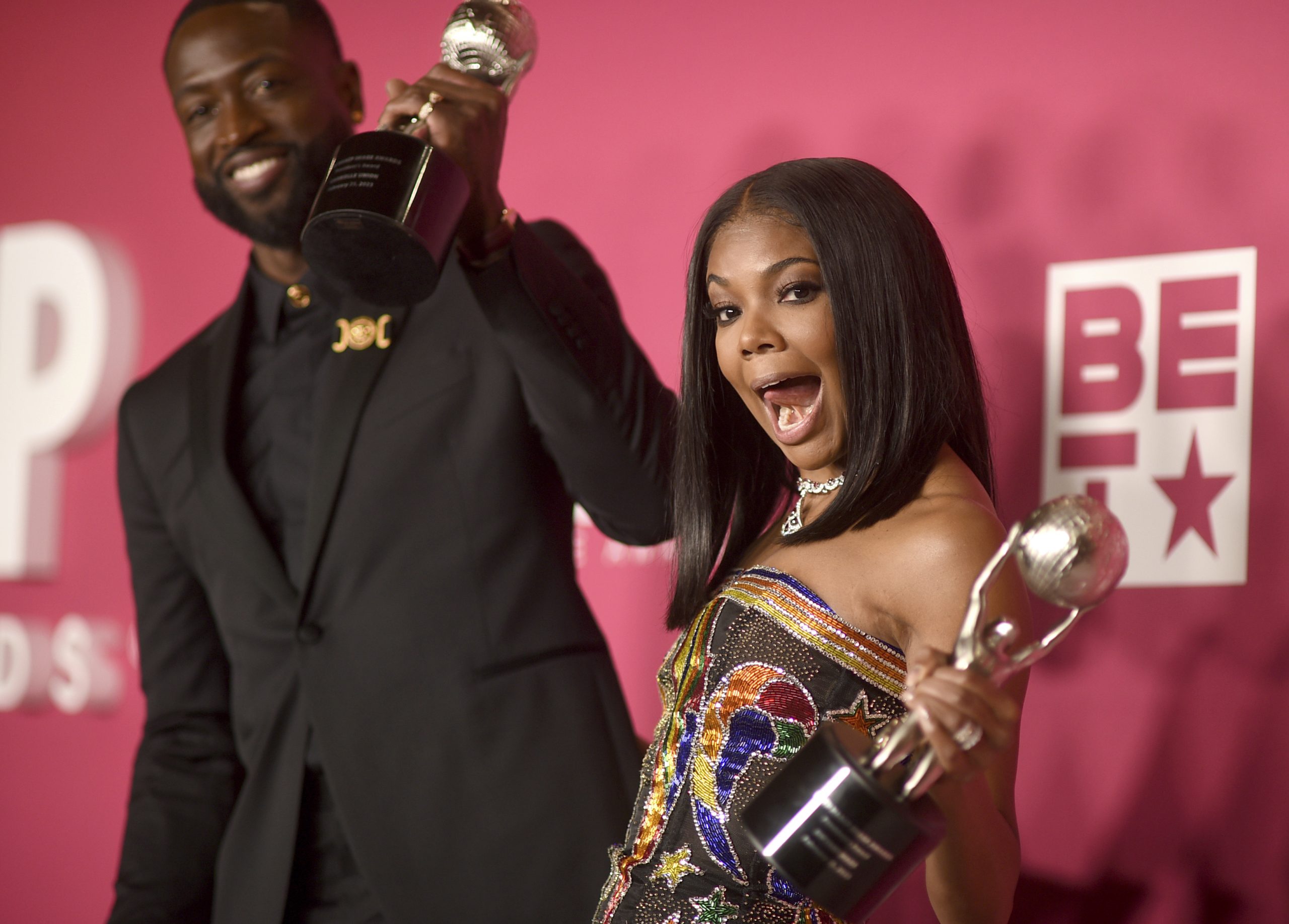 Dwyane Wade and Gabrielle Union-Wade celebrate receiving an award at the NAACP Image Awards.