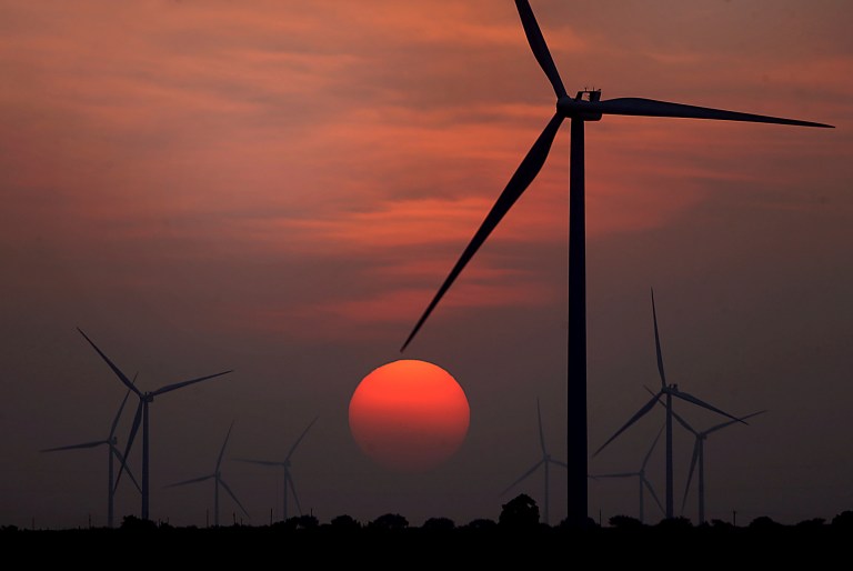 File - The sun sets at wind farm in McCook, Texas during a heat wave on Wednesday, July 20, 2022. (Delcia Lopez/The Monitor via AP, File)