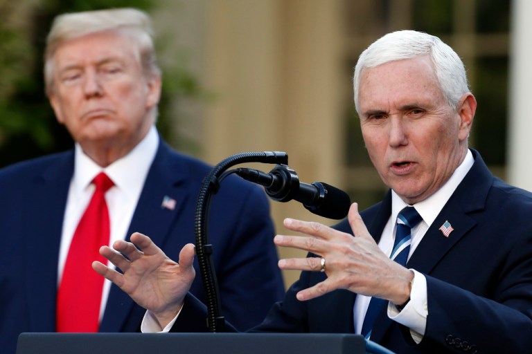 President Donald Trump listens as Vice President Mike Pence speaks about the coronavirus in the Rose Garden of the White House, April 27, 2020, in Washington.