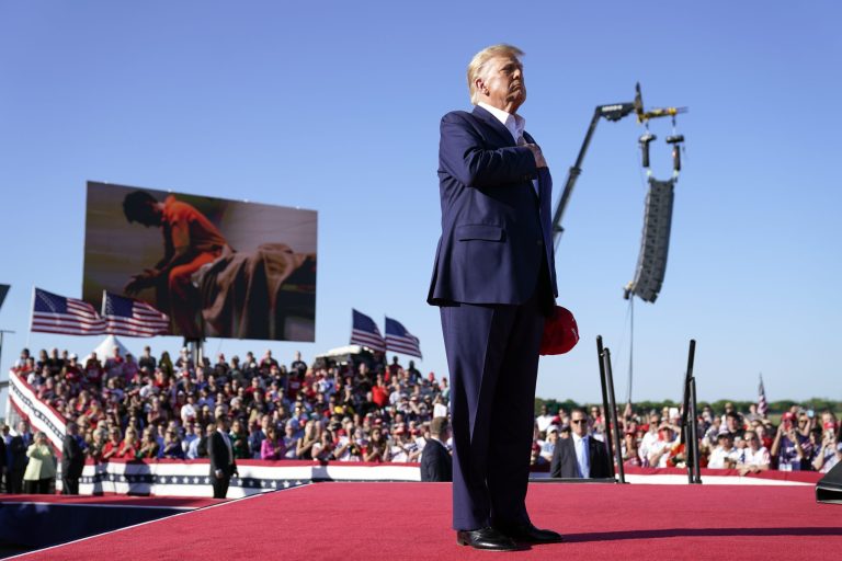 Former President Donald Trump stands while a song, 