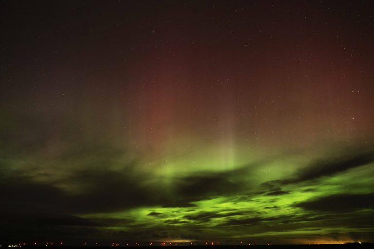 An aurora borealis, also known as the northern lights, is seen in the sky in the early morning hours.
