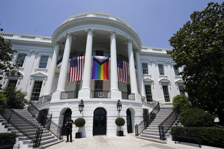 American flags and a pride flag hang from the White House during a Pride Month celebration on the South Lawn, Saturday, June 10, 2023, in Washington. 