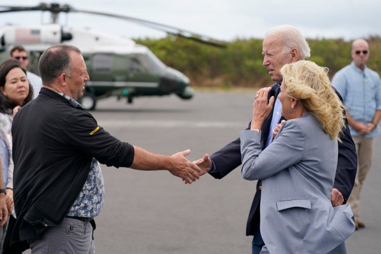 President Joe Biden and first lady Jill Biden greet Hawaii Gov. Josh Green upon arrival on Air Force One to receive a briefing on the devastating Maui wildfires and the ongoing recovery efforts, Monday, Aug. 21, 2023, in Kahului, Hawaii.