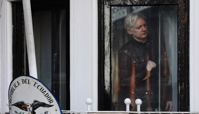 Julian Assange, founder of WikiLeaks, opens the door to a balcony to speak to media and supporters at the Ecuadorian embassy in London, U.K., on on Friday, May 19, 2017. Assange hailed a Swedish decision to drop a rape probe against him, but said he won't leave the Ecuadorian embassy in London where he has sought refuge for the past five years as long as he remains a target in the U.S. and U.K.