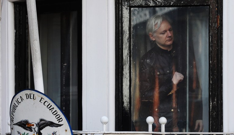 Julian Assange, founder of WikiLeaks, opens the door to a balcony to speak to media and supporters at the Ecuadorian embassy in London, U.K., on on Friday, May 19, 2017. Assange hailed a Swedish decision to drop a rape probe against him, but said he won't leave the Ecuadorian embassy in London where he has sought refuge for the past five years as long as he remains a target in the U.S. and U.K.