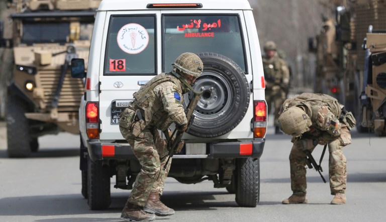 British soldiers with NATO-led Resolute Support Mission forces checks an ambulance at the site of an attack in Kabul, Afghanistan, Friday, March 6, 2020. Gunmen in Afghanistan's capital of Kabul attacked a remembrance ceremony for a minority Shiite leader on Friday, wounding more than a dozen of people, officials said. 