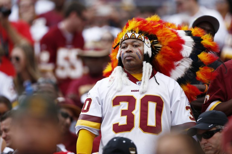 A Washington Redskins fan wearing Indian headdress watches a game between the Redskins and Detroit Lions. (AP/Joe Robbins)