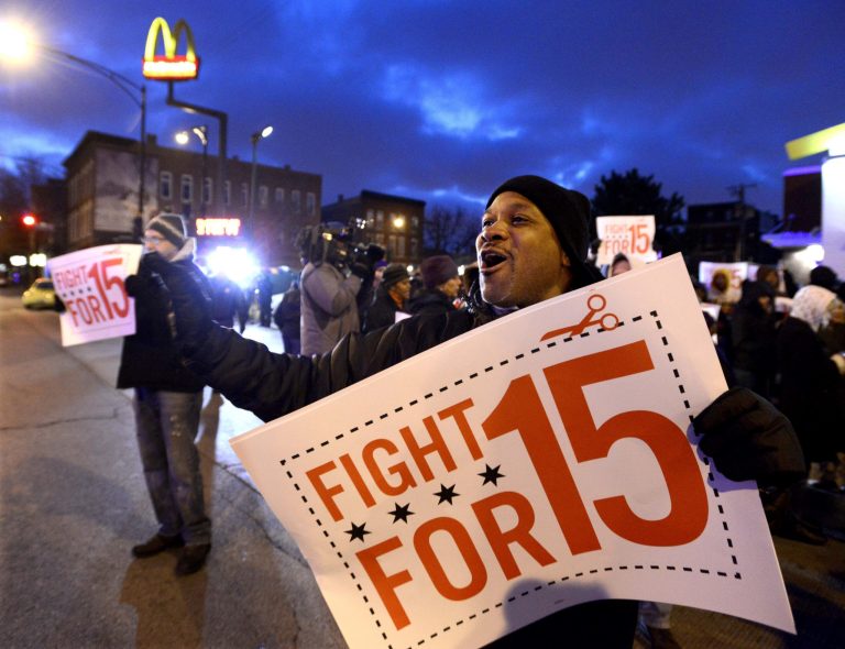 Demonstrators rally for better wages outside a McDonald's restaurant in Chicago, Thursday, Dec. 5, 2013. Demonstrations planned in 100 cities are part of push by labor unions, worker advocacy groups and Democrats to raise the federal minimum wage of $7.25 to $15. (AP Photo/Paul Beaty)