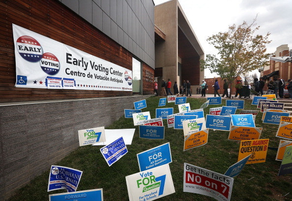 Campaign signs and voters in line for early voting at the Silver Spring Civic Building (Getty Images)