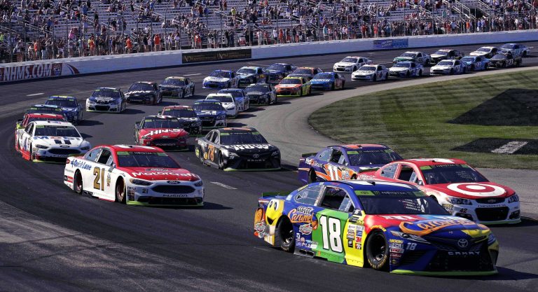 Kyle Busch (18) leads the pack into turn one in the first lap of the NASCAR Cup Series 300 auto race at New Hampshire Motor Speedway in Loudon, N.H., Sunday, Sept. 24, 2017. (AP Photo/Charles Krupa)