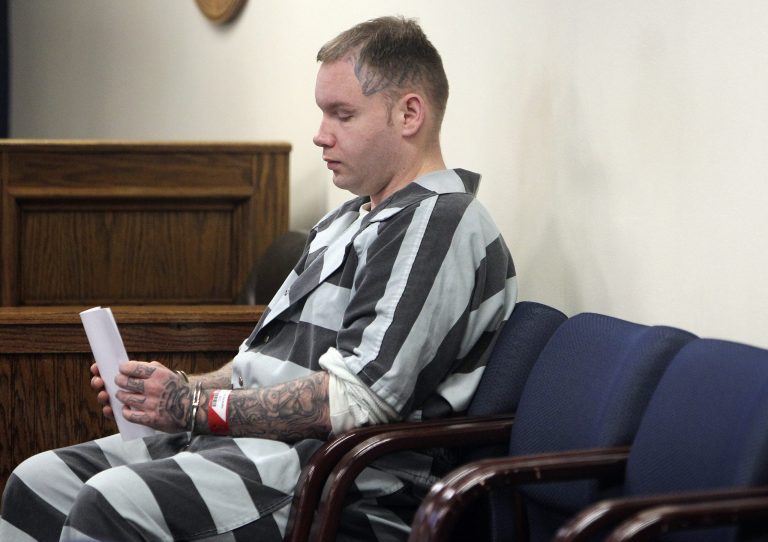 Don Willburn Collins waits to be placed into the custody of the Montgomery County Sheriff's Office following a hearing at the 359th Judicial District Court with Judge Kathleen Hamilton on March 6 in Conroe, Texas. Hamilton, now 28, accused of dousing Robert Middleton with gasoline and setting him on fire in 1998 when he was a teenager, can be tried as an adult for murder after the victim died from his burns nearly 13 years later, Judge Collins ruled Thursday.  (AP Photo/ The Courier, Jason Fochtman) 