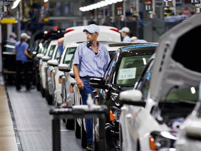 Employees at the Volkswagen plant in Chattanooga, Tenn., work on a Passat sedan. (AP/Erik Schelzig)
