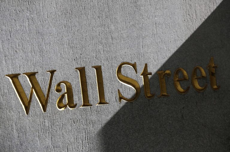 FILE - This March 4, 2013 file photo shows a sign for Wall Street on the side of building near the New York Stock Exchange, in New York. European stocks advanced Wednesday July 16, 2014 after China's economic growth picked up slightly in the second quarter but Asian markets were lukewarm about the data that largely fitted expectations. (AP Photo/Mark Lennihan, File)