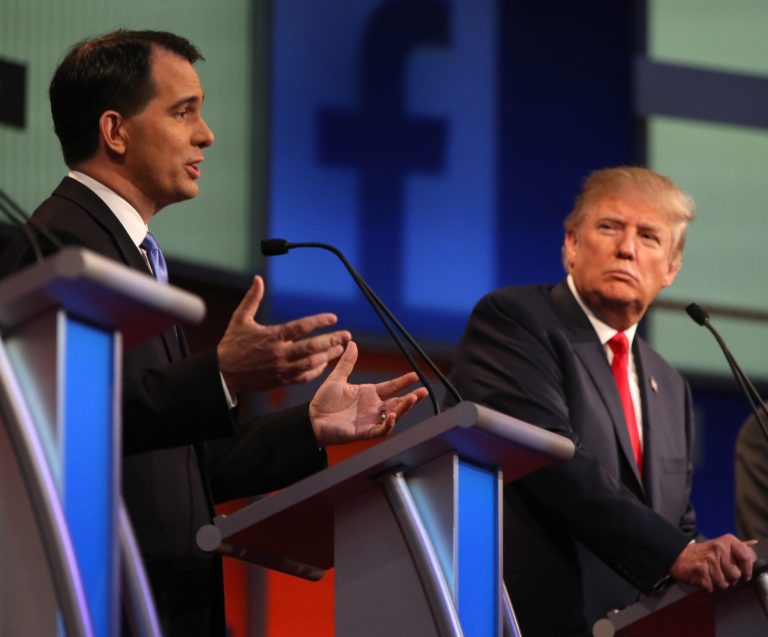 Wisconsin Gov. Scott Walker speaks as Donald Trump listens during the first Republican presidential debate on Thursday, Aug. 6, 2015. Walker officially suspended his campaign onÂ Sept. 21. (AP Photo/Andrew Harnik)