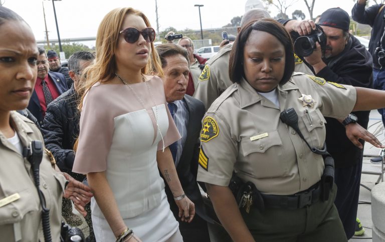 Actress Lindsay Lohan arrives at the Los Angeles Superior court Monday, March 18, 2013. Lohan is charged with three misdemeanor counts stemming from a crash on Pacific Coast Highway. She is charged with willfully resisting, obstructing or delaying an officer, providing false information to an officer and reckless driving. She is also accused of violating her probation in a misdemeanor jewelry theft case. (AP Photo/Damian Dovarganes)
