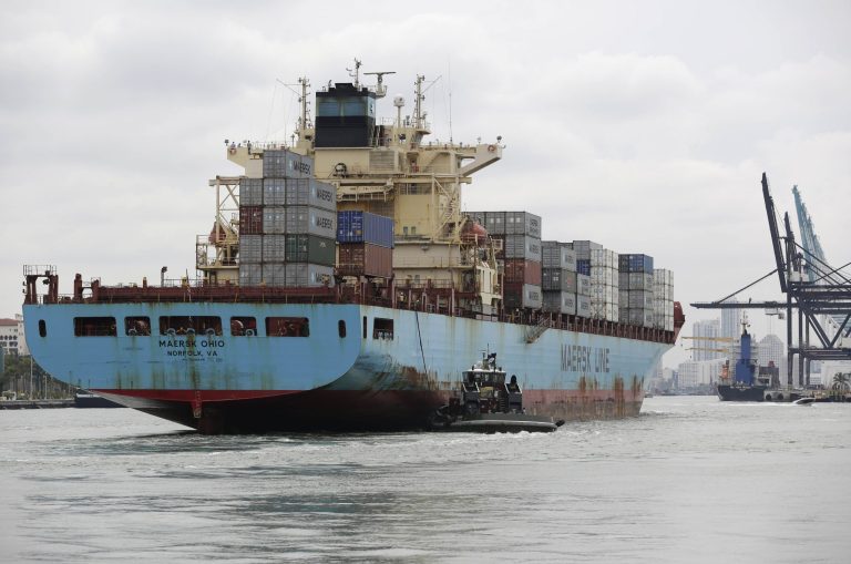 In this Friday, May 16, 2014 photo, a Maersk Line vessel is guided by a tugboat as it heads into the Port of Miami off of Miami Beach, Fla.  The Commerce Department reports on the U.S. current account trade deficit for the April-June quarter on Wednesday, Sept. 17, 2014. (AP Photo/Lynne Sladky)