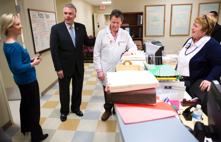 Virginia Gov. Terry McAuliffe, second left, meets with Dr. Patrick Neustatter in the Lloyd F. Moss Free Clinic at Mary Washington Hospital in Fredericksburg, Va., on March 7. (AP Photo/The Free Lance-Star, Autumn Parry)