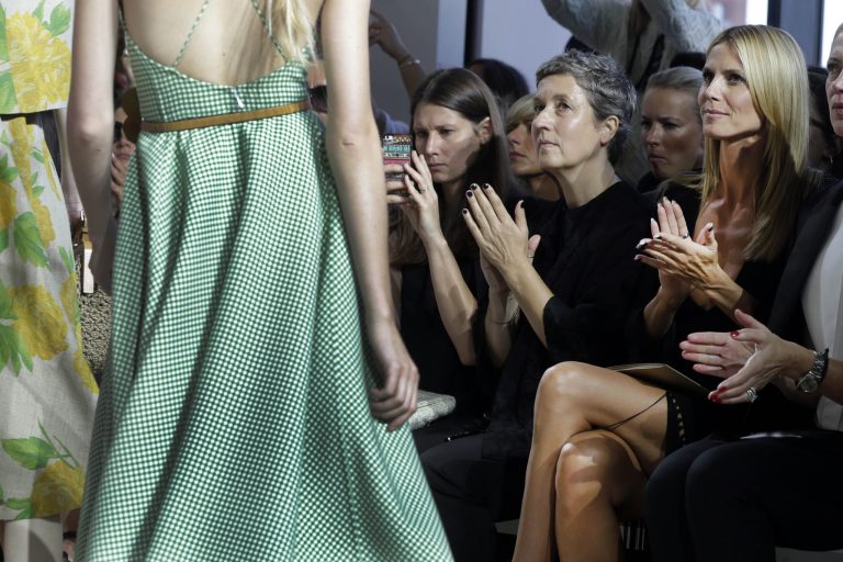 Model Heidi Klum, right, applauds as she watches the finale of the Michael Kors Spring 2015 collection, modeled during Fashion Week, in New York, Wednesday, Sept. 10, 2014. (AP Photo/Richard Drew)