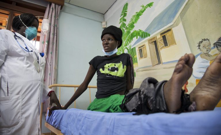 FILE - This is a Thursday, Feb. 27, 2014 file photo of  a newly-diagnosed HIV positive woman, who arrived at the hospital with symptoms of tuberculosis (TB), receives treatment at the Mildmay Uganda clinic in Kampala, Uganda .   The number of people living with HIV worldwide has remained virtually unchanged in the past two years and AIDS-related deaths are at their lowest since peaking almost a decade ago, according to a report from the United Nations AIDS agency released Wednesday July 16, 2014. (AP Photo/Rebecca Vassie, File)