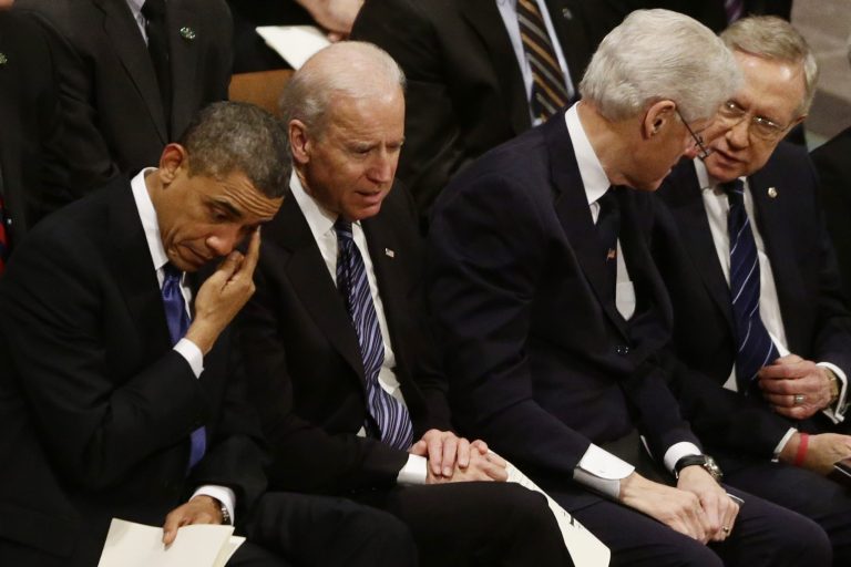   President Barack Obama wipes his eye as he is seated with Vice President Joe Biden, former President Bill Clinton, and Senate Majority Leader Harry Reid at the funeral service for the late Sen. Daniel Inouye, D-Hawaii, at the Washington National Cathedral, Friday, Dec. 21, 2012. (AP Photo/Charles Dharapak)  