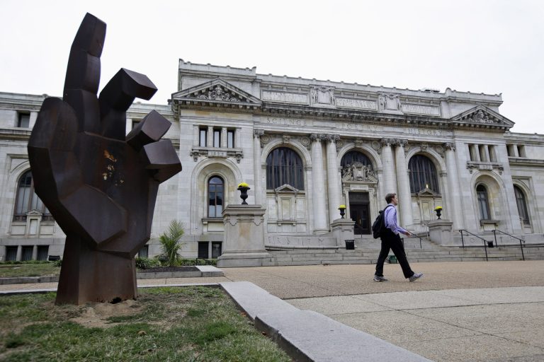   A man walks past the historic Carnegie Library building in Washington, Monday, Sept. 23, 2013. The International Spy Museum, one of the hottest attractions in the nationâs capital over the past decade, is considering a move to a historic library that would give it more space for exhibits and a link to the cityâs convention center. (AP Photo/Jacquelyn Martin)  
