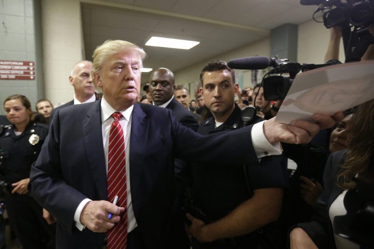 Republican presidential candidate, businessman Donald Trump signs autographs as he arrives at a campaign stop, Wednesday, Sept. 30, 2015, in Keene, N.H. (AP Photo/Steven Senne)