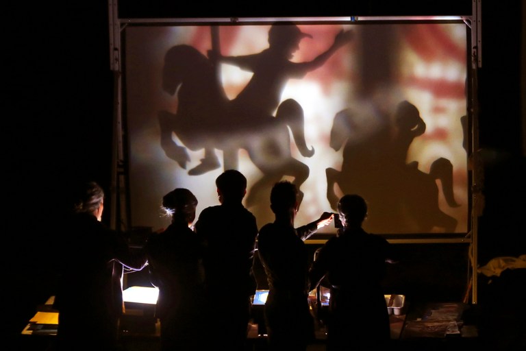 In this Thursday, Sept. 18, 2014 photo, American artists from the Manual Cinema group perform a live cinematic shadow puppet show during the Tehran Mobarak Puppet Festival at the City Theater in Iran. Hundreds of Iranian art lovers gave a troupe of Chicago-based puppeteers flowers and a lengthy standing ovation at the Tehran City Theater at the end of their historic performance this week during a rare visit by American performers to the Islamic Republic. (AP Photo/Vahid Salemi)