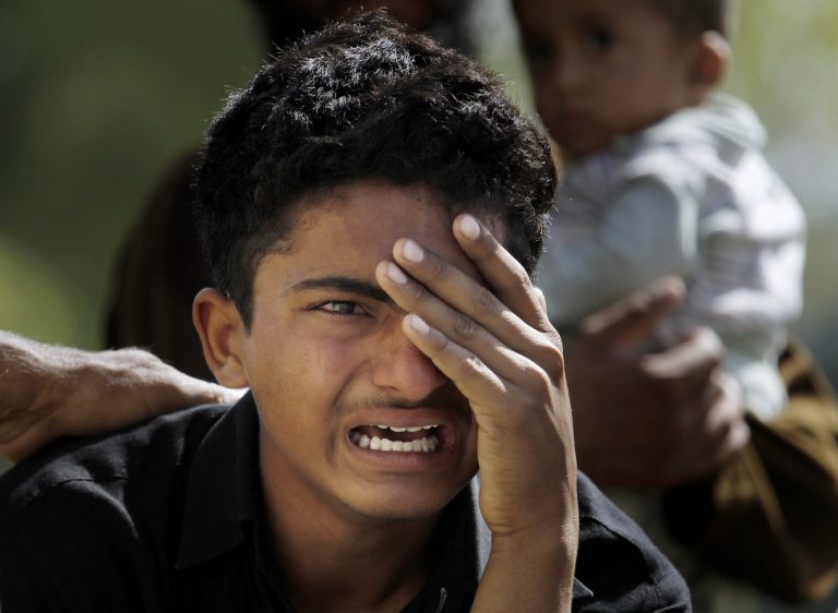 A Pakistani boy mourns over the death of his family member, a victim of bomb blast, outside a morgue in a local hospital in Islamabad, Pakistan, Wednesday, April 9, 2014. A bomb ripped through a fruit and vegetable market on the outskirts of the Pakistani capital of Islamabad on Wednesday morning, killing scores of people and leaving dozens more wounded, officials said. (AP Photo/Anjum Naveed)