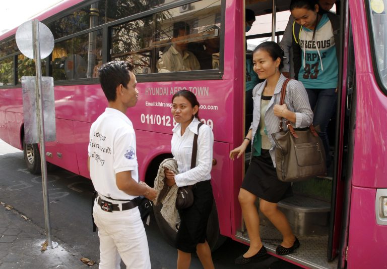 Cambodian passengers disembark from a bus as Phnom Penh begins its trial for public bus service, Wednesday, Feb. 5, 2014, in Phnom Penh, Cambodia.  People in Phnom Penh boarded city buses Wednesday for the first time in over a decade, as authorities introduced a public transportation system aimed at relieving traffic jams in the Cambodian capital. (AP Photo/Heng Sinith)