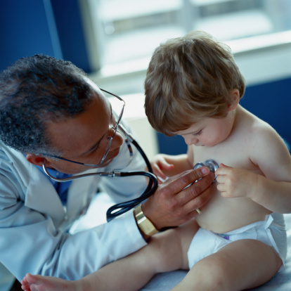 Doctor Using Stethoscope to Examine Toddler