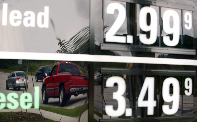   In this Monday, July 1, 2013, photo, vehicles are reflected in a sign advertising unleaded gas for $2.99 at a QuikTrip station at the corner of Woodruff Rd. and Verdae Blvd. in Greenville, S.C. The government reports on consumer prices for July on Thursday, Aug. 15, 2013. (AP Photo/Rainier Ehrhardt)  
