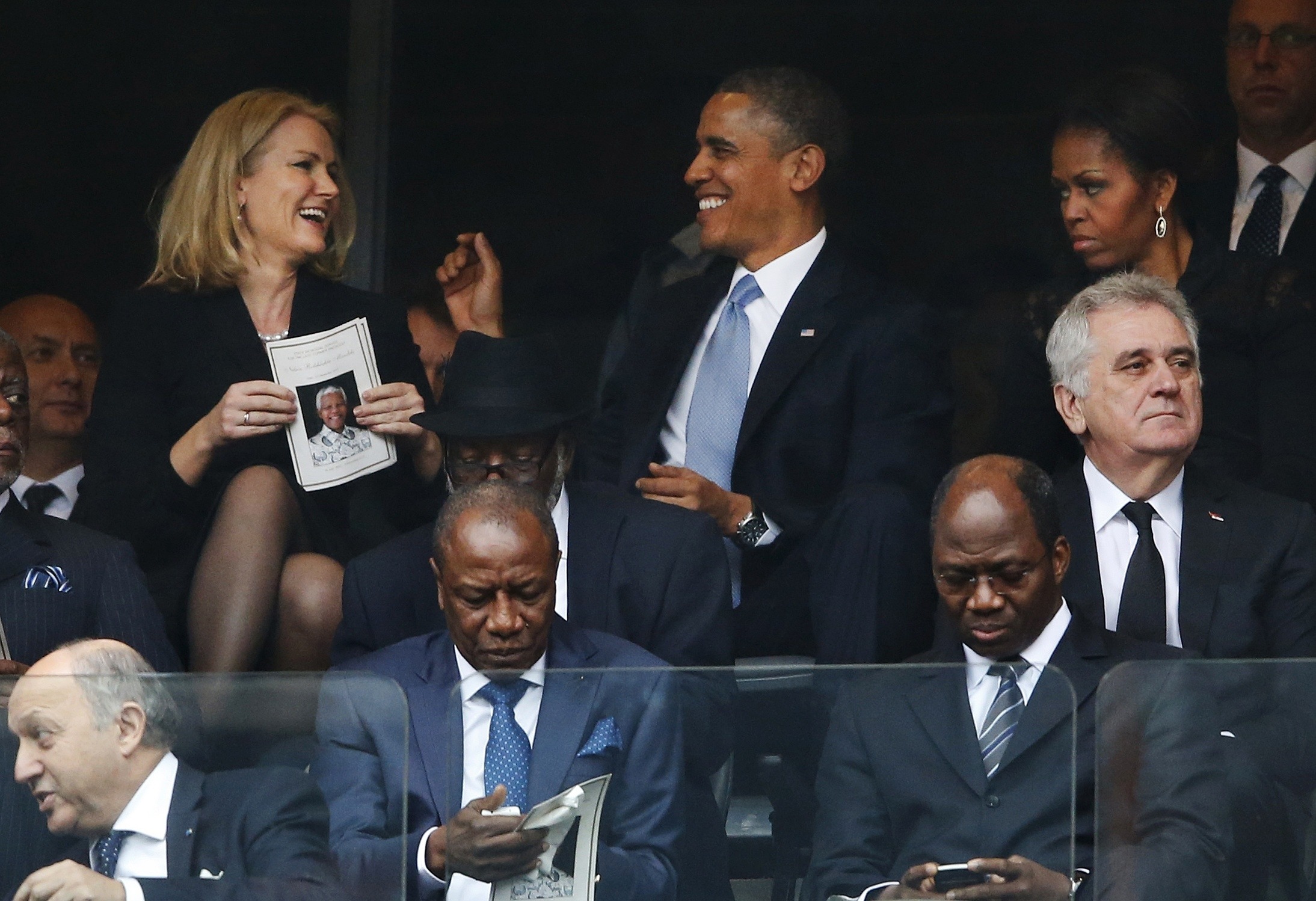 Obama laughs, takes selfie at Nelson Mandela funeral