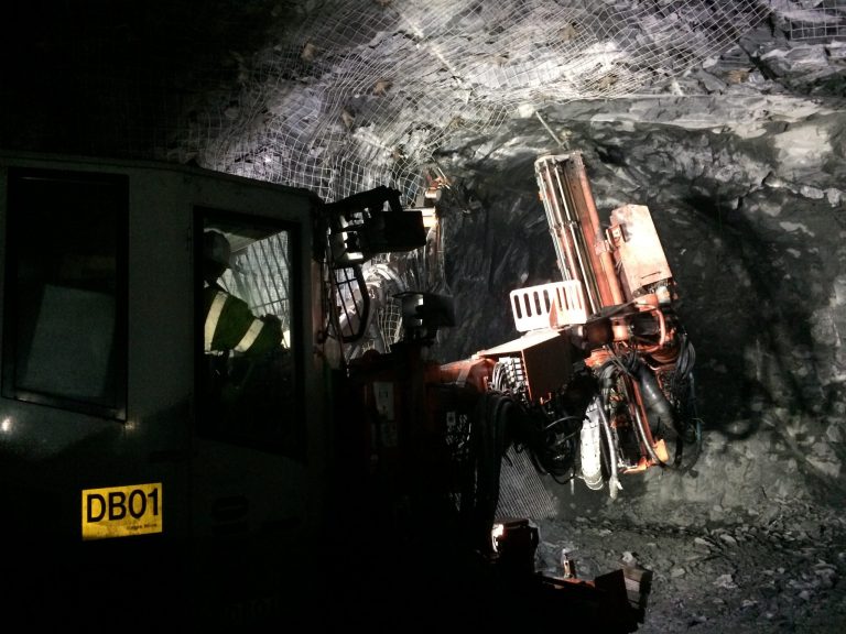In this May, 2014 photo provided by Eagle Mine a rock bolter, which drills and installs bolts to stabilize the mine, moves through a tunnel at  the mine in Marquette County, Mich. The nickel and copper operation, scheduled to begin production this fall, will pump $4 billion into Marquette County over its eight-year lifespan and employ about 300 while generating economic activity that will create 1,200 additional jobs, according to the company. (AP Photo/Courtesy Eagle Mine)