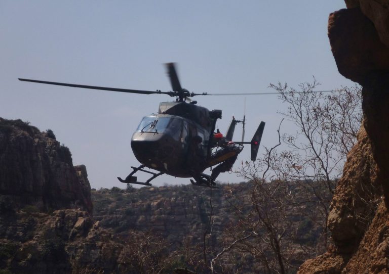 In this  handout photo supplied by the Mountain Club of SA Search and Rescue and taken Sunday Sept. 21, 2014 a helicopter is loaded with a stretcher carrying  Tsenolo Shadrack Rasello from The Kloof, a tourist destination near Johannesburg in Rustenburg South Africa. South African rescue workers recently performed surgery on the side of a cliff, amputating the leg of  Rasello, whose foot was jammed between rocks in a drama reminiscent of the ordeal of Aron Ralston, the American climber who cut off his own arm to escape from a remote Utah canyon.  Rasello used his cellular telephone, setting off a tense and complex rescue operation that included several helicopters and more than 100 people. (AP Photo/Mountain Club of SA Search and Rescue )   MANDATORY CREDIT