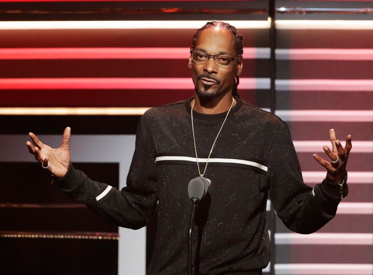 Snoop Dogg's new music video aims a toy gun at a clown dressed as President Trump. (AP Photo/David Goldman, File)