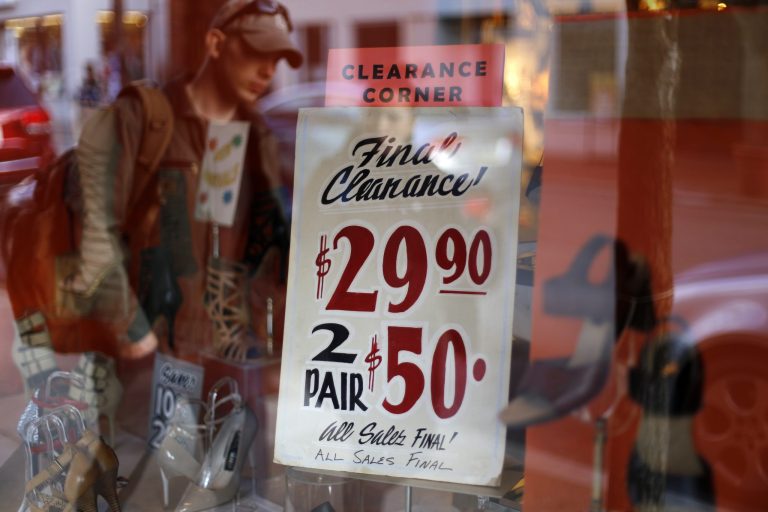 In this March 24, 2014,  photo,  sale sign is displayed in a shoe store in the Shadyside shopping district of Pittsburgh. The Commerce Department releases personal income and spending for February on Friday, March 28, 2014. (AP Photo/Gene J. Puskar)